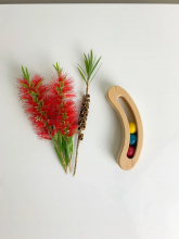 Photograph of Wooden 3 Ball Boomerang Rattle Natural Finish with Rainbow Balls